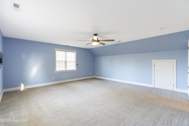 carpeted empty room with ceiling fan and vaulted ceiling