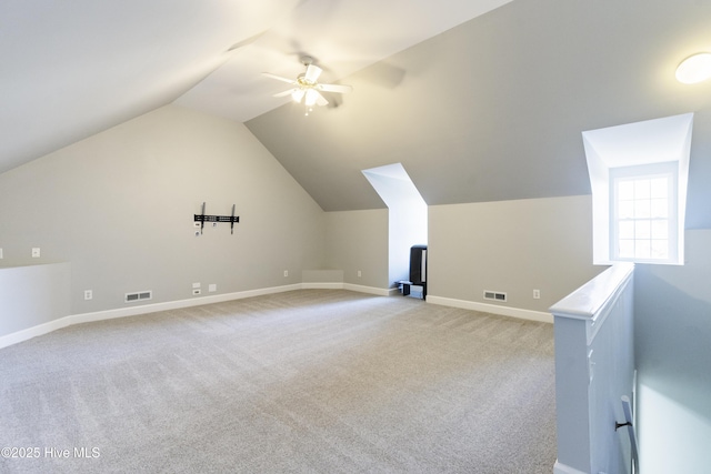 bonus room featuring lofted ceiling, light colored carpet, and ceiling fan