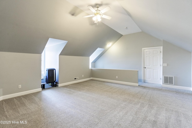 additional living space with light carpet, vaulted ceiling, and ceiling fan