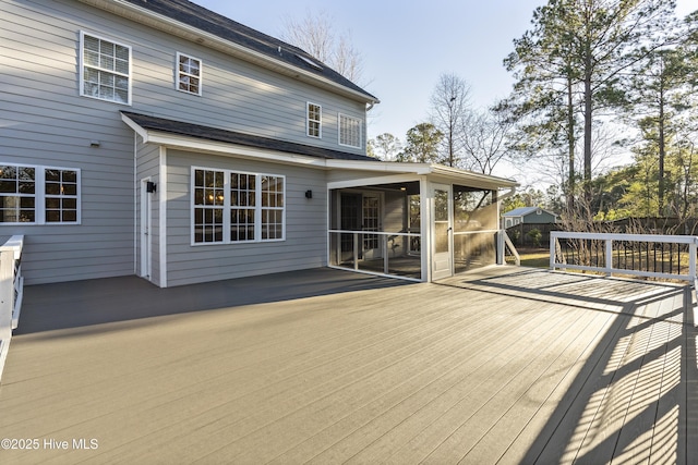 wooden deck with a sunroom