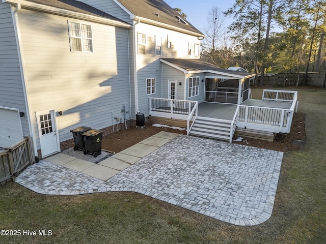 back of house with central AC, a patio area, a yard, a wooden deck, and a sunroom