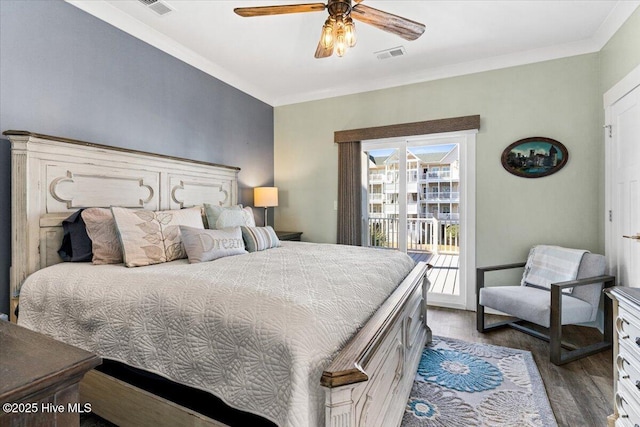 bedroom with access to exterior, dark wood-style flooring, crown molding, visible vents, and ceiling fan