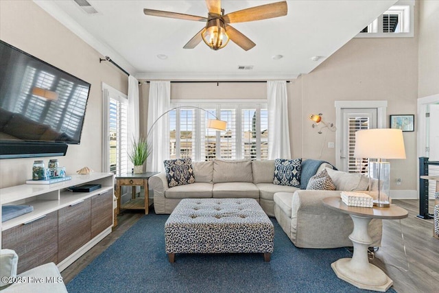 living area featuring a ceiling fan, visible vents, and wood finished floors