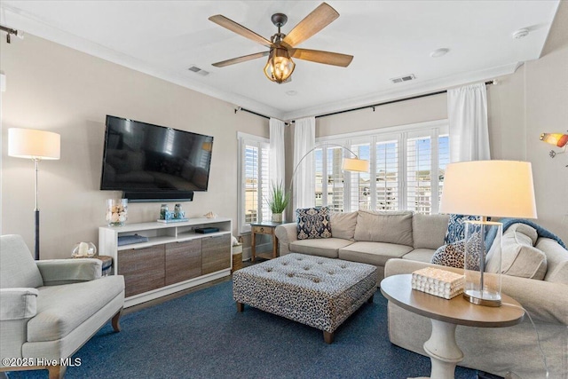 living area with ceiling fan and visible vents