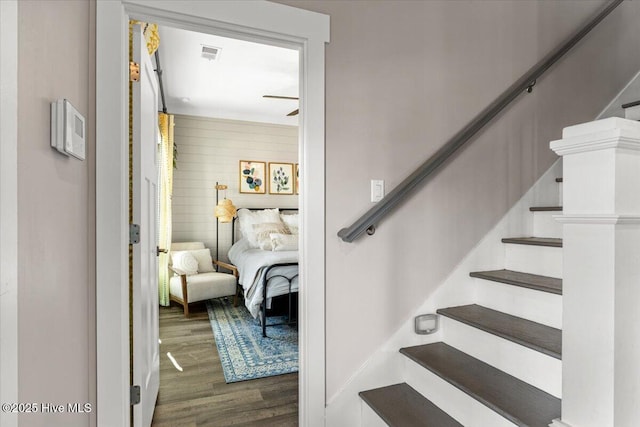 stairs with visible vents and wood finished floors