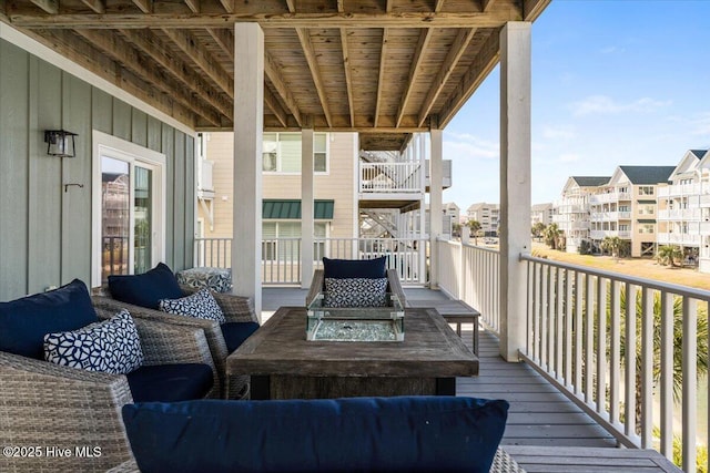 wooden terrace featuring a residential view and an outdoor hangout area