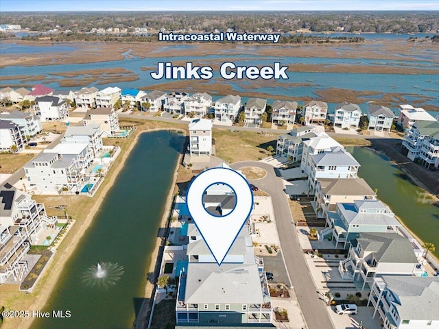 drone / aerial view featuring a residential view and a water view