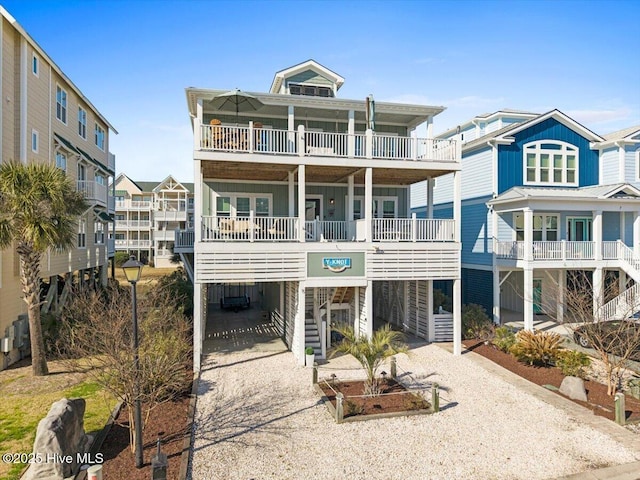 coastal home with a carport and gravel driveway