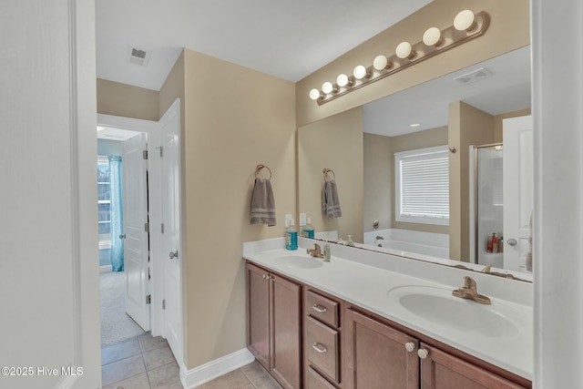 bathroom featuring a bath, vanity, and tile patterned flooring