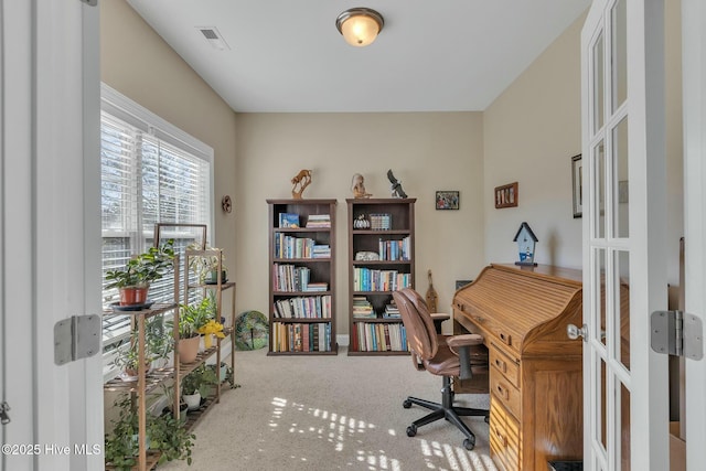 carpeted office featuring french doors