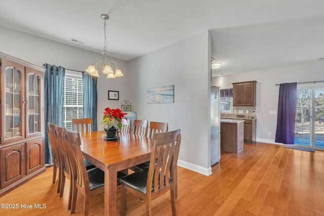 dining area featuring a chandelier and light hardwood / wood-style floors