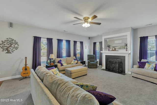 carpeted living room with ceiling fan