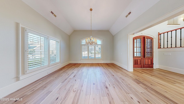 unfurnished dining area featuring light wood-type flooring, an inviting chandelier, and vaulted ceiling