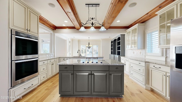 kitchen with gray cabinets, appliances with stainless steel finishes, backsplash, hanging light fixtures, and beamed ceiling