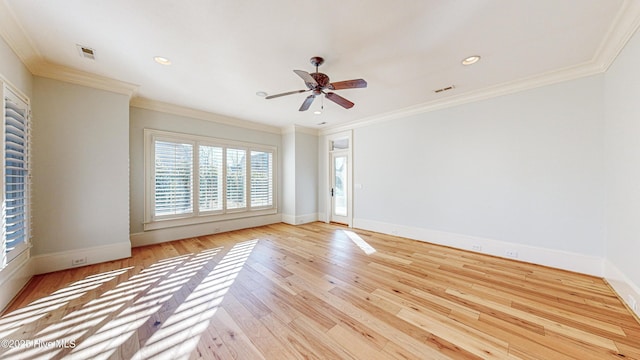 empty room featuring ceiling fan, light wood-type flooring, and ornamental molding