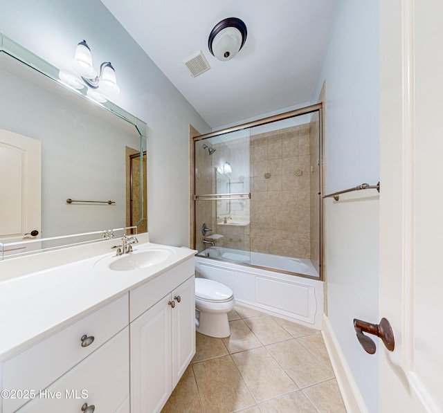 full bathroom with toilet, tile patterned flooring, vanity, and shower / bath combination with glass door