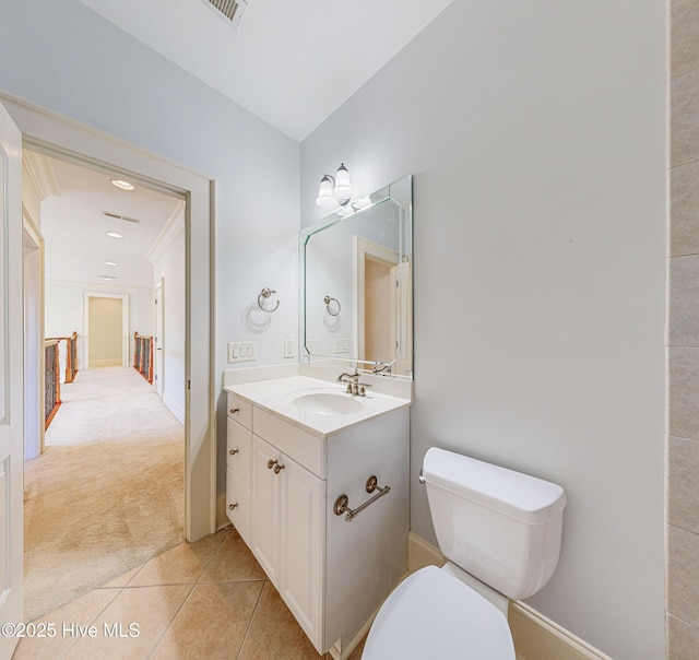 bathroom with toilet, tile patterned floors, and vanity