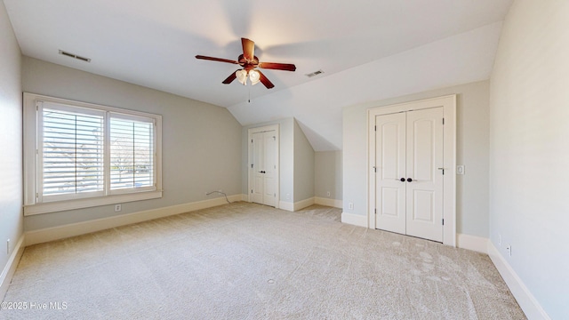 bonus room with vaulted ceiling, ceiling fan, and light carpet