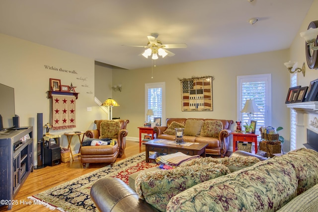 living room featuring ceiling fan and hardwood / wood-style flooring