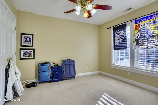 interior space with light carpet, ceiling fan, and a wealth of natural light