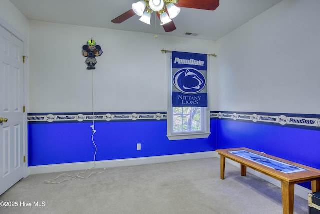 interior space featuring ceiling fan and carpet flooring