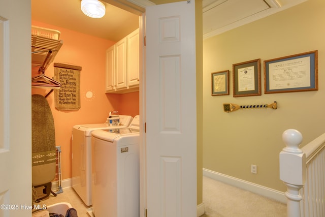 washroom with light carpet, washing machine and dryer, and cabinets