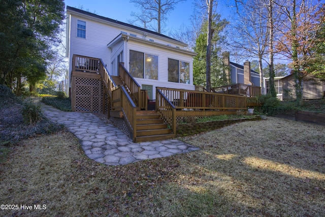 back of house with a wooden deck