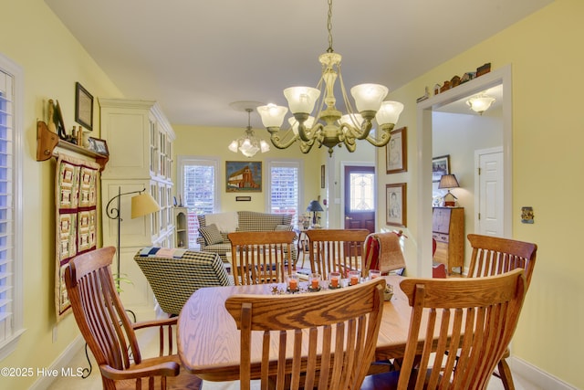 dining room with plenty of natural light and an inviting chandelier