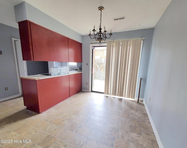 kitchen featuring hanging light fixtures and a chandelier