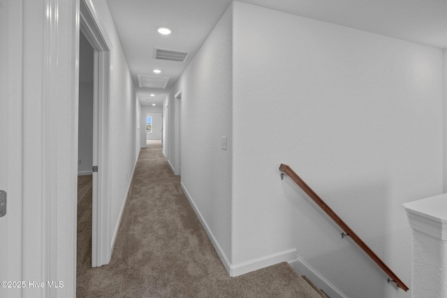 hallway featuring light colored carpet