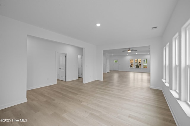 unfurnished living room featuring ceiling fan and light hardwood / wood-style floors