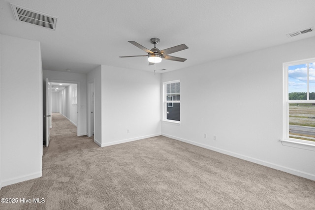 carpeted empty room featuring ceiling fan