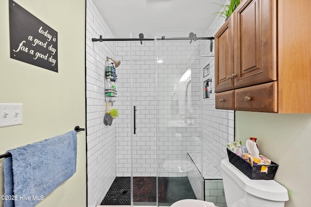 bathroom with walk in shower and toilet