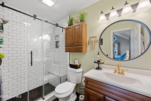 bathroom with vanity, a shower with door, and toilet