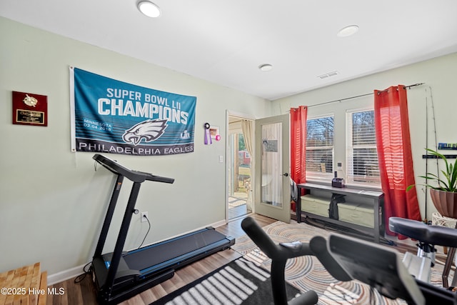 exercise area featuring hardwood / wood-style flooring