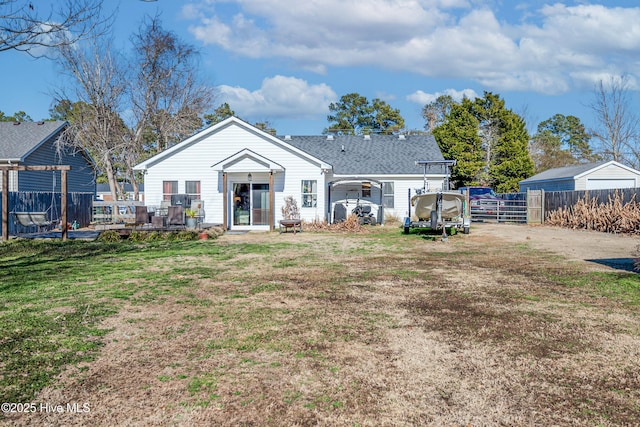 back of house with a wooden deck and a yard