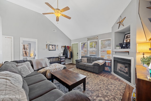 living room featuring ceiling fan, high vaulted ceiling, and hardwood / wood-style floors