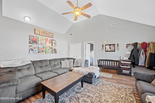 living room with ceiling fan, wood-type flooring, and high vaulted ceiling