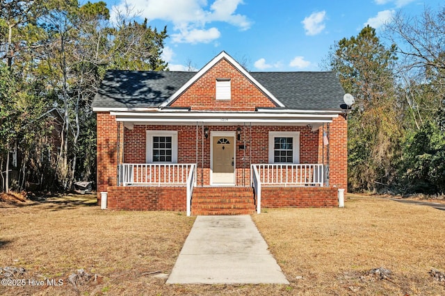 bungalow with a front yard and a porch