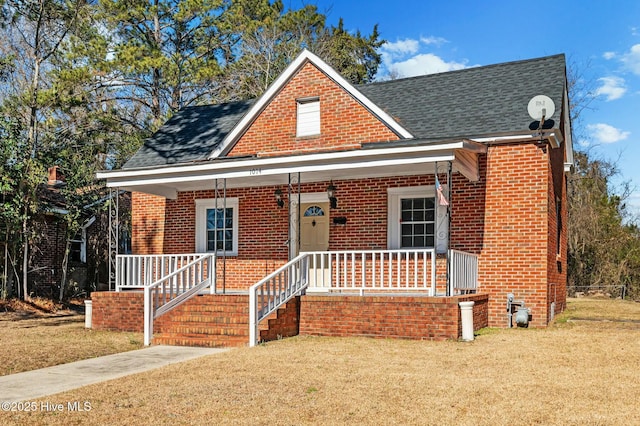 bungalow-style house featuring a porch and a front lawn