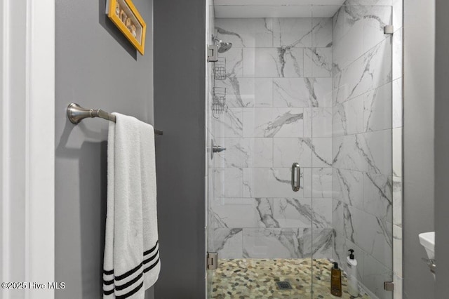 bathroom featuring toilet and an enclosed shower