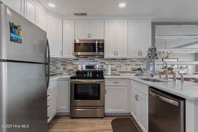 kitchen featuring sink, stainless steel appliances, and white cabinetry