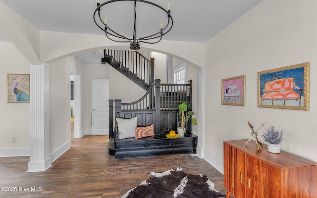 staircase featuring a chandelier and hardwood / wood-style flooring