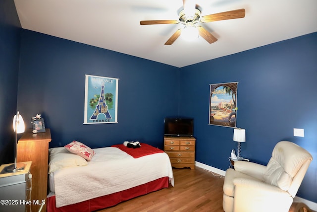 bedroom with hardwood / wood-style floors and ceiling fan