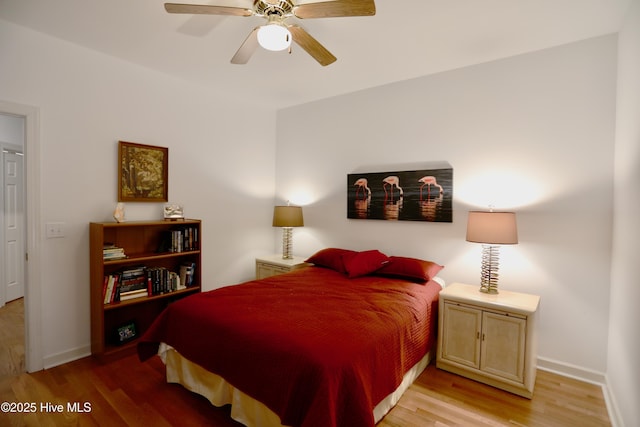 bedroom with ceiling fan and hardwood / wood-style flooring