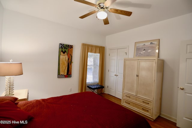 bedroom with hardwood / wood-style flooring, a closet, and ceiling fan