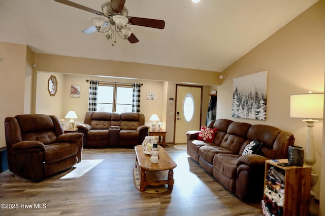 living room with ceiling fan, vaulted ceiling, and hardwood / wood-style floors