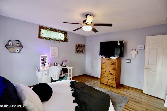 bedroom with ceiling fan and wood-type flooring