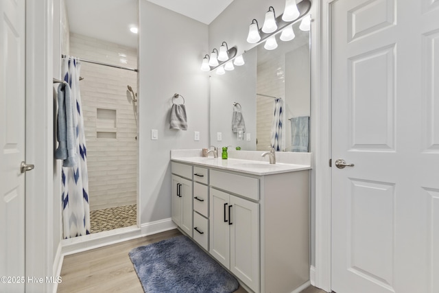 bathroom with wood-type flooring, vanity, and a shower with curtain