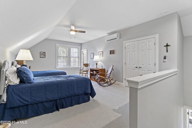 bedroom with carpet, lofted ceiling, a closet, a wall mounted AC, and ceiling fan